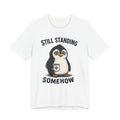Still Standing Somehow Penguin T-Shirt – Cute Resilient Animal Graphic Tee